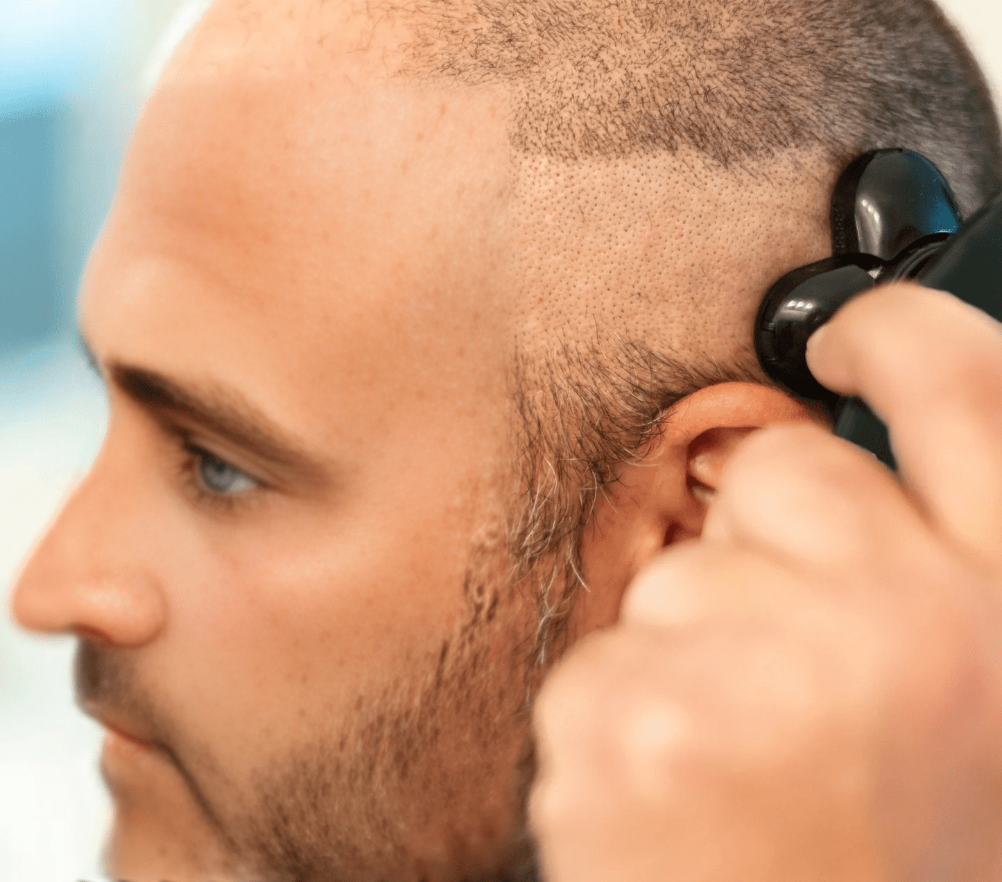 Man using ShaveMate™ Elite 5D rotary electric shaver for a close, smooth head shave with precision and comfort.