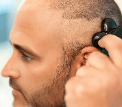 Man using ShaveMate™ Elite 5D rotary electric shaver for a close, smooth head shave with precision and comfort.